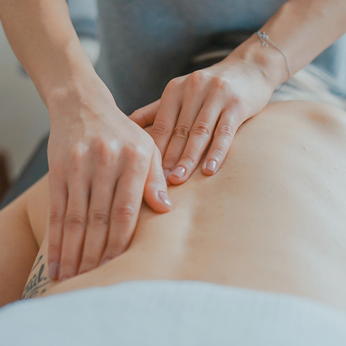 Person receiving a back massage to aid in inflammation