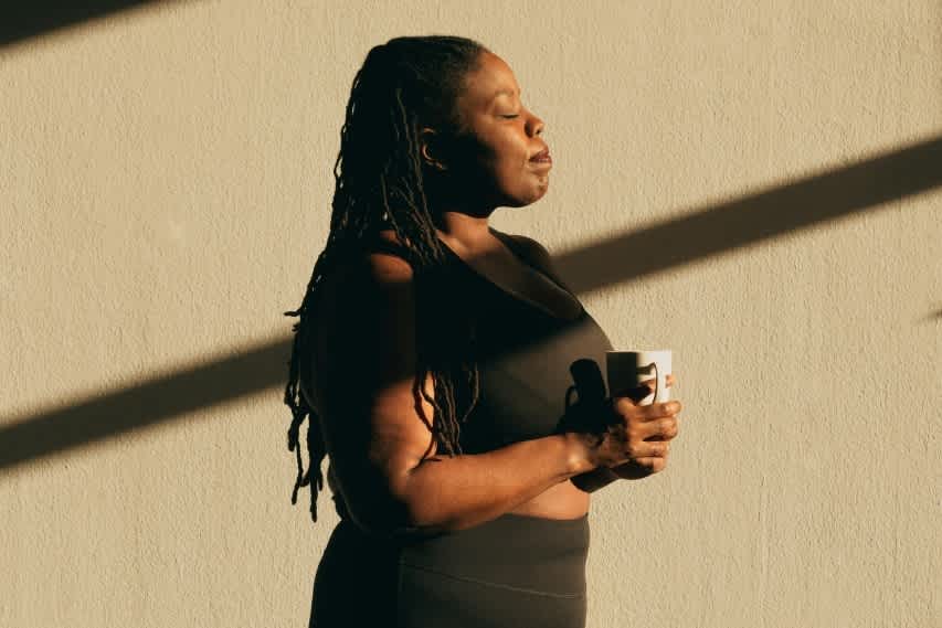 woman in sun with coffee