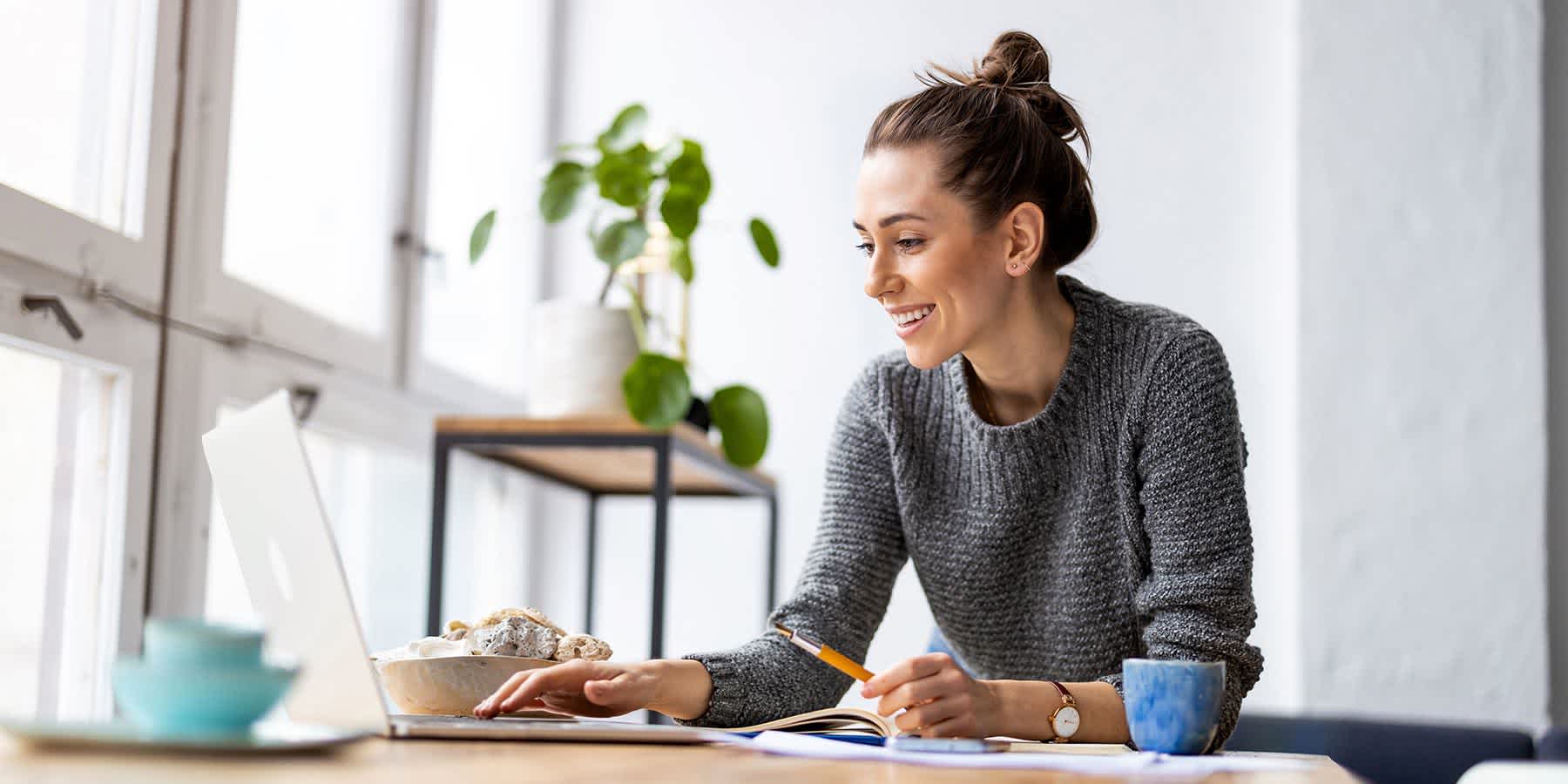 Woman using laptop to look up the best food for digestion