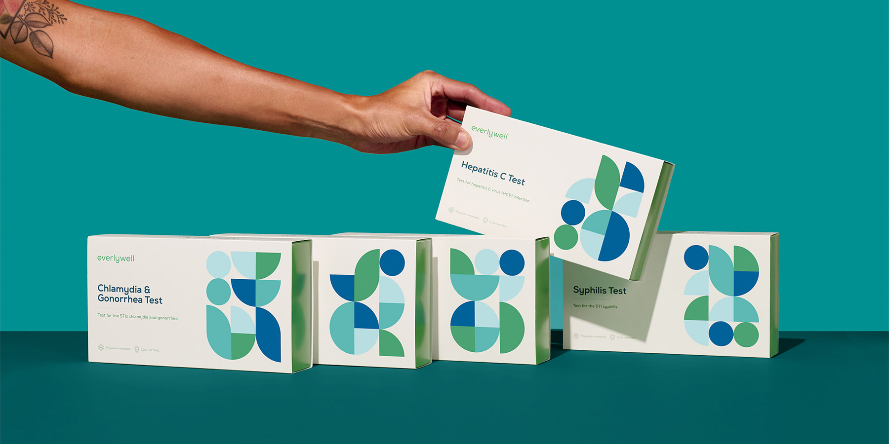 Person picking up an Everlywell STD Test kit box after finding out how often you should get tested for STDs