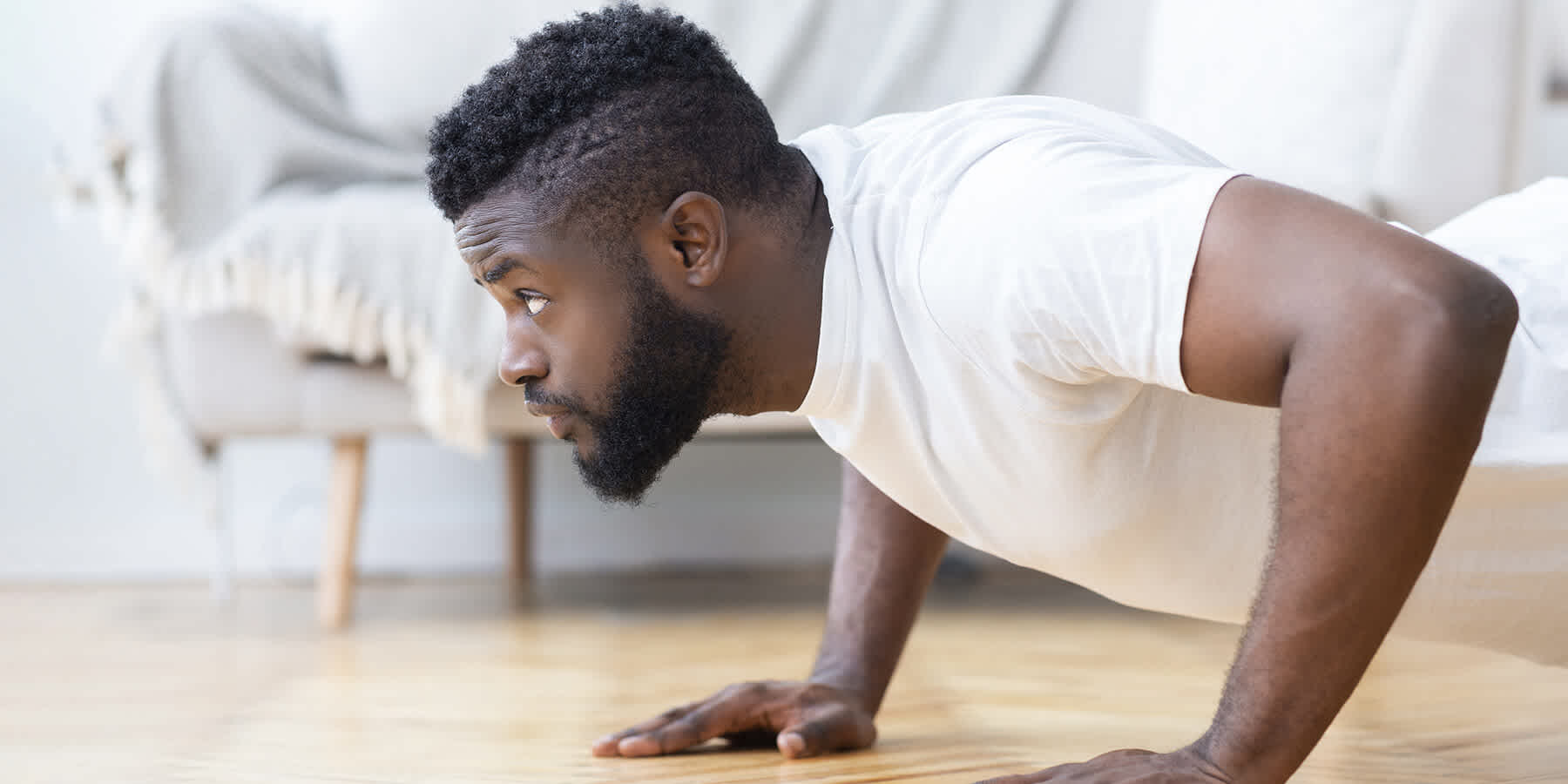 Young man doing push-ups while experiencing the benefits of DHEA