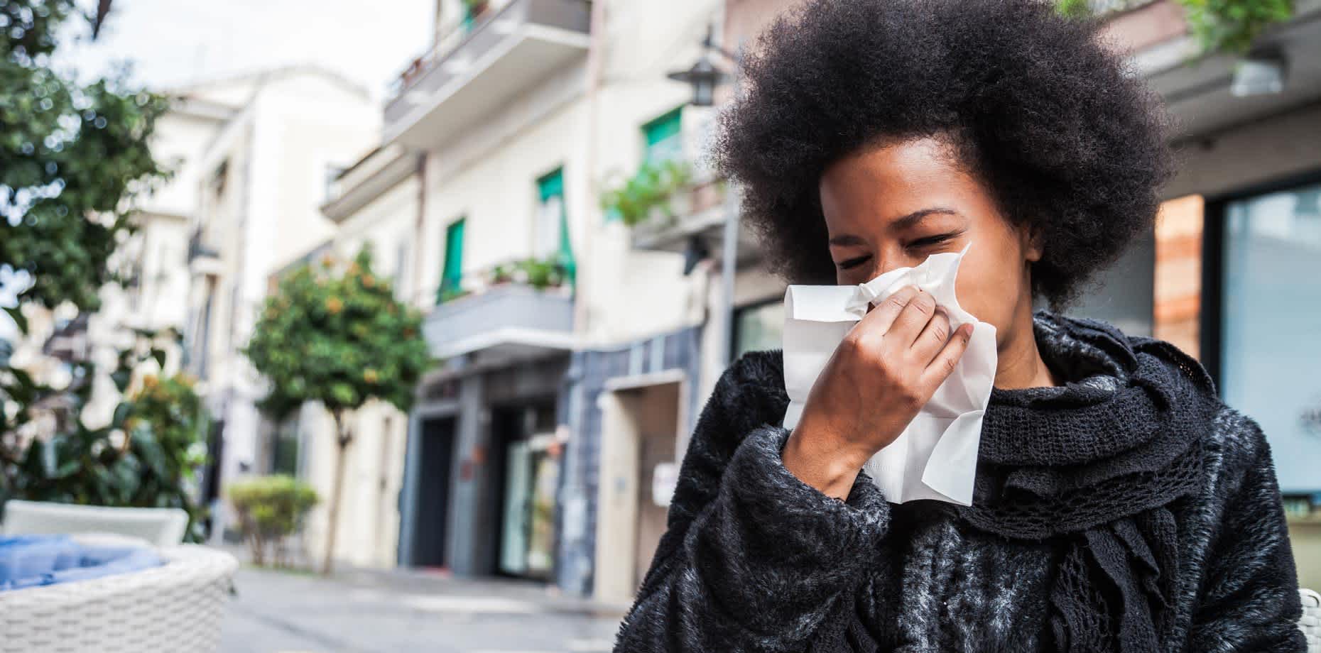 Woman with allergies about to sneeze