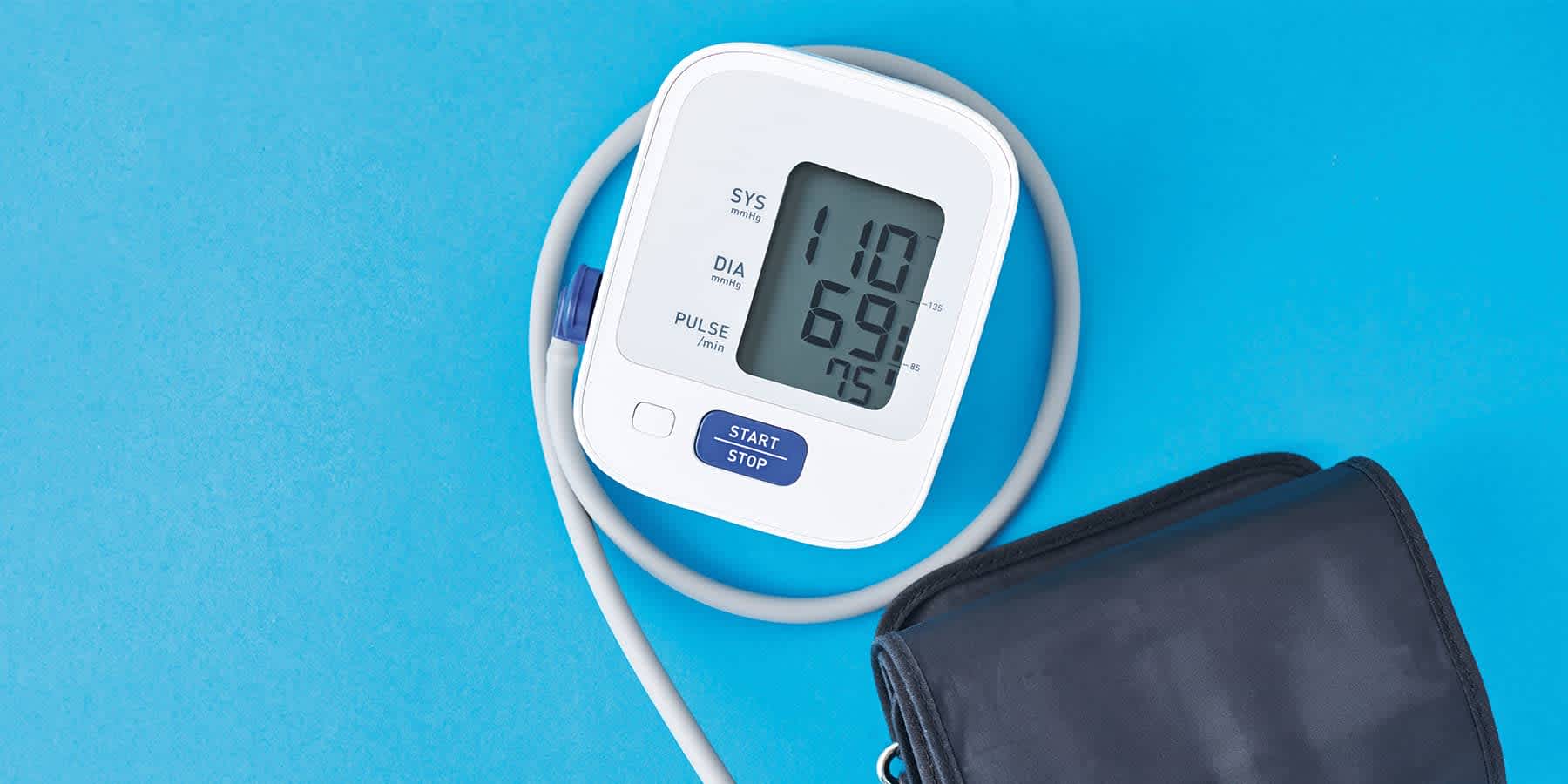Blood pressure monitor against blue background to help with heart disease management