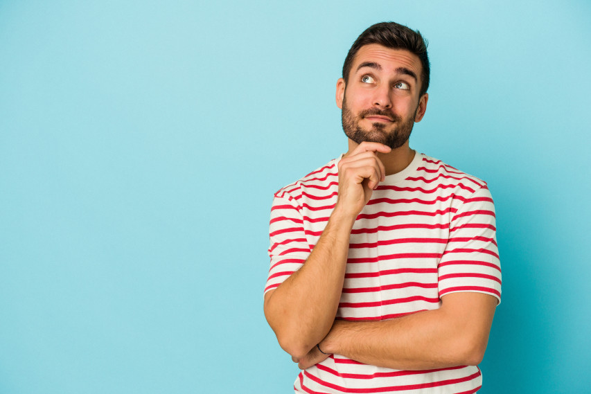 man in red striped shirt with light blue background