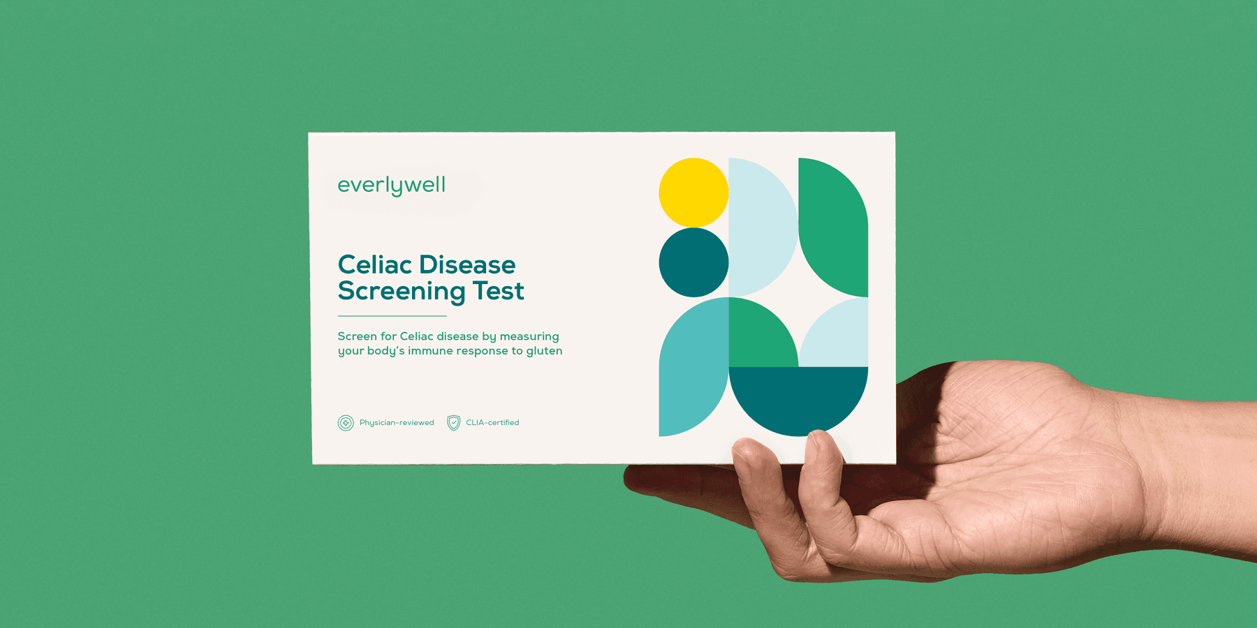 Person holding kit box for at-home Celiac Disease Screening Test