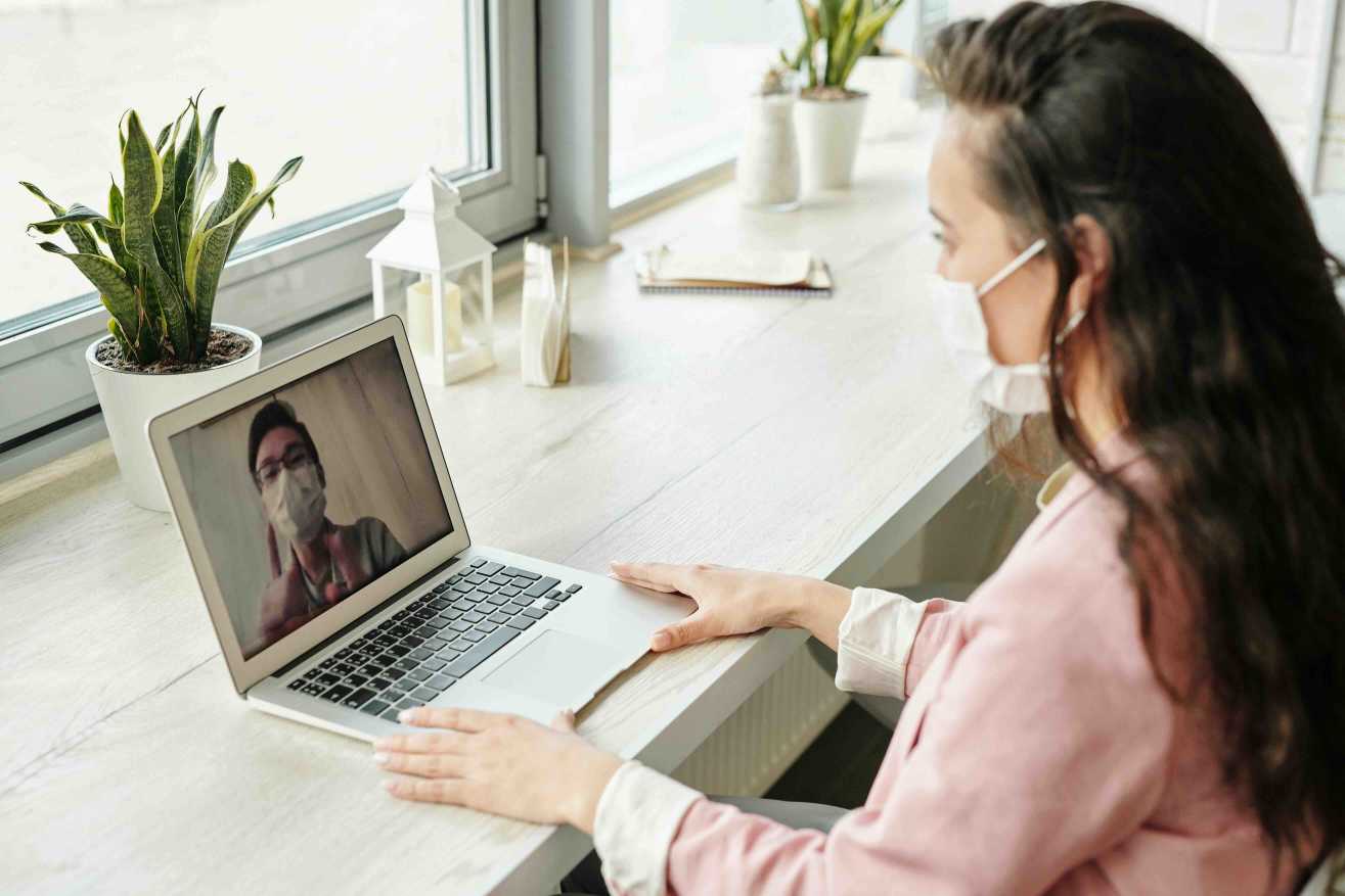 Healthcare provider discussing fluctuating UTI symptoms with patient via telehealth
