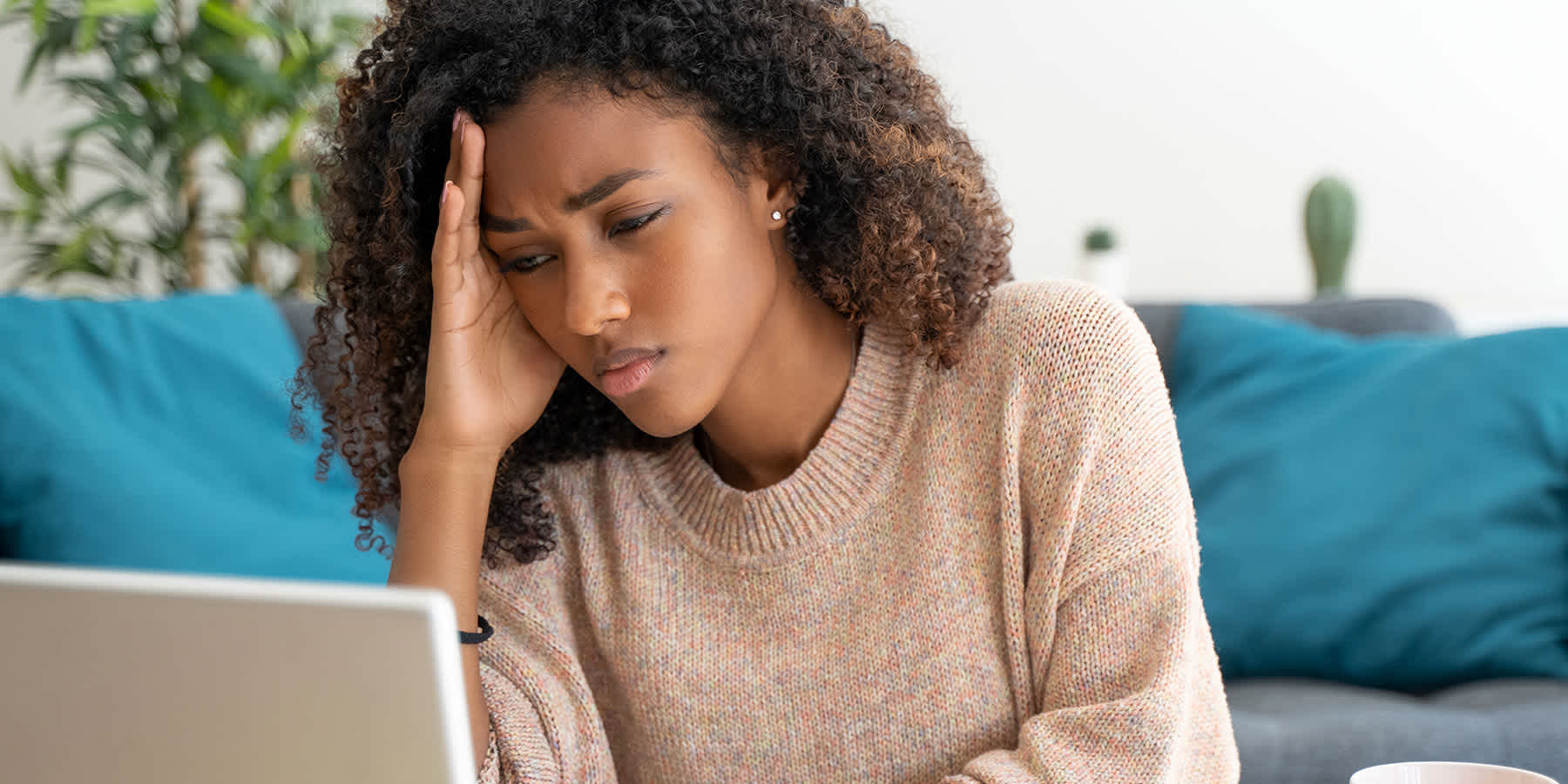 Young woman with laptop getting diagnosis online