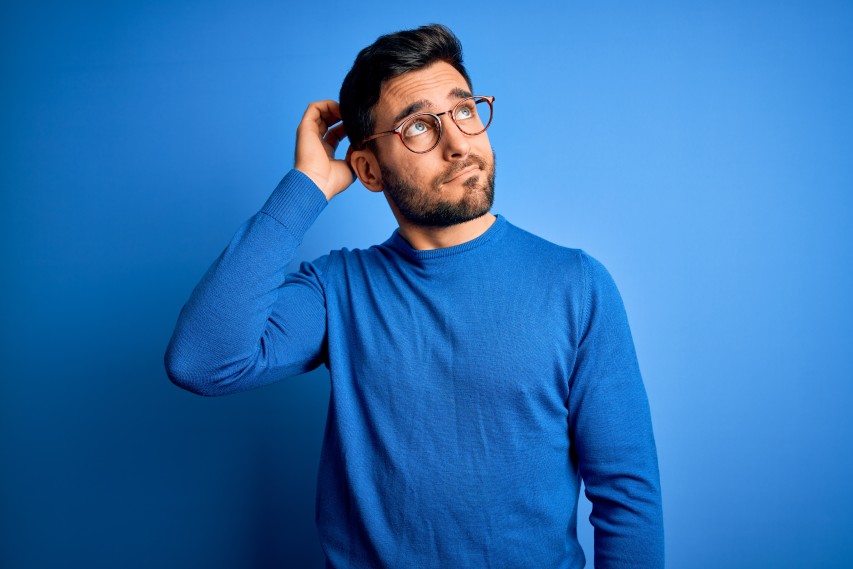 man in blue with blue background thinking