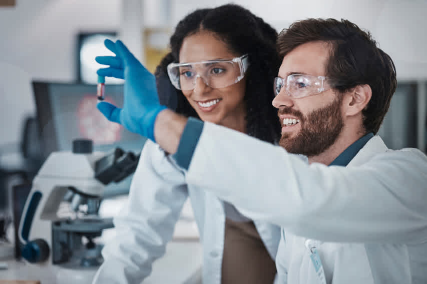 lab workers with vile of blood