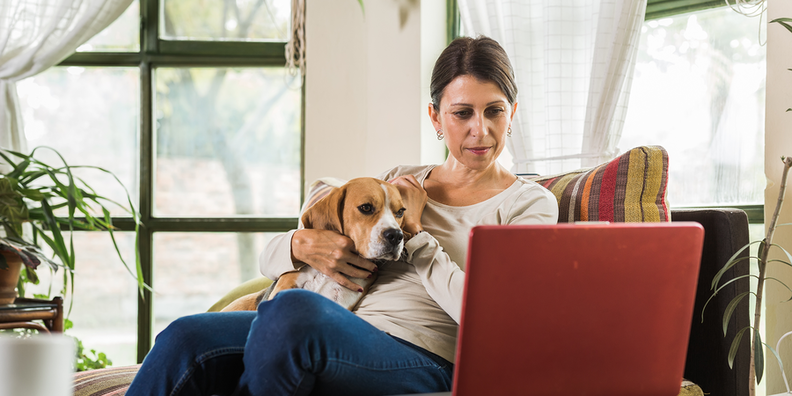 Woman on laptop looking up when to stop intermittent fasting