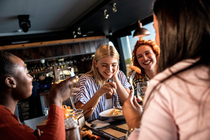 friends laughing at a restaurant table