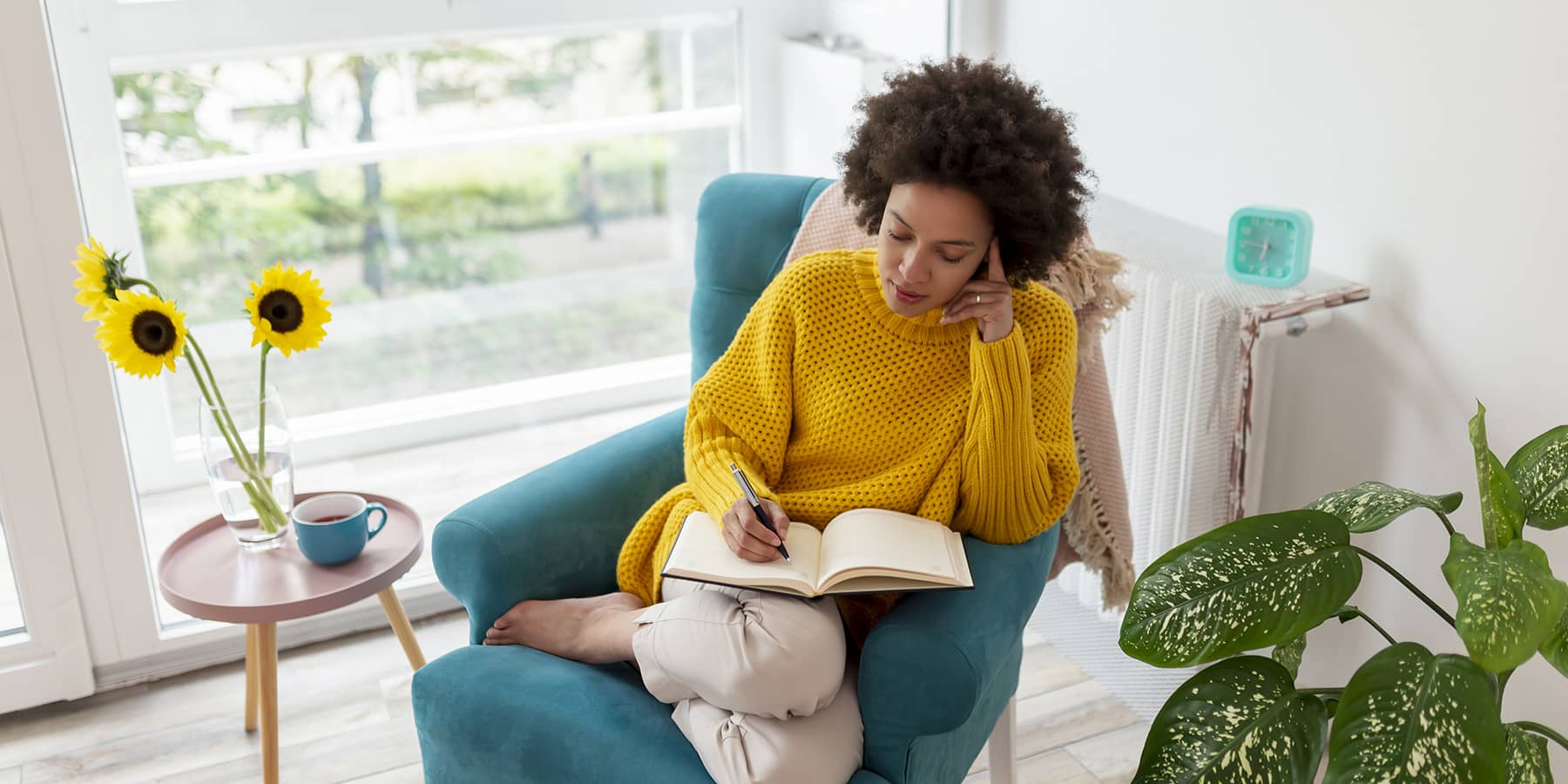 Young woman sitting on chair and researching the signs of colon cancer in women