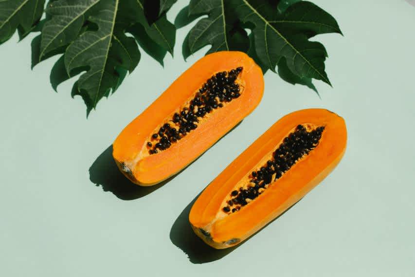 flat lay papaya on mint green background