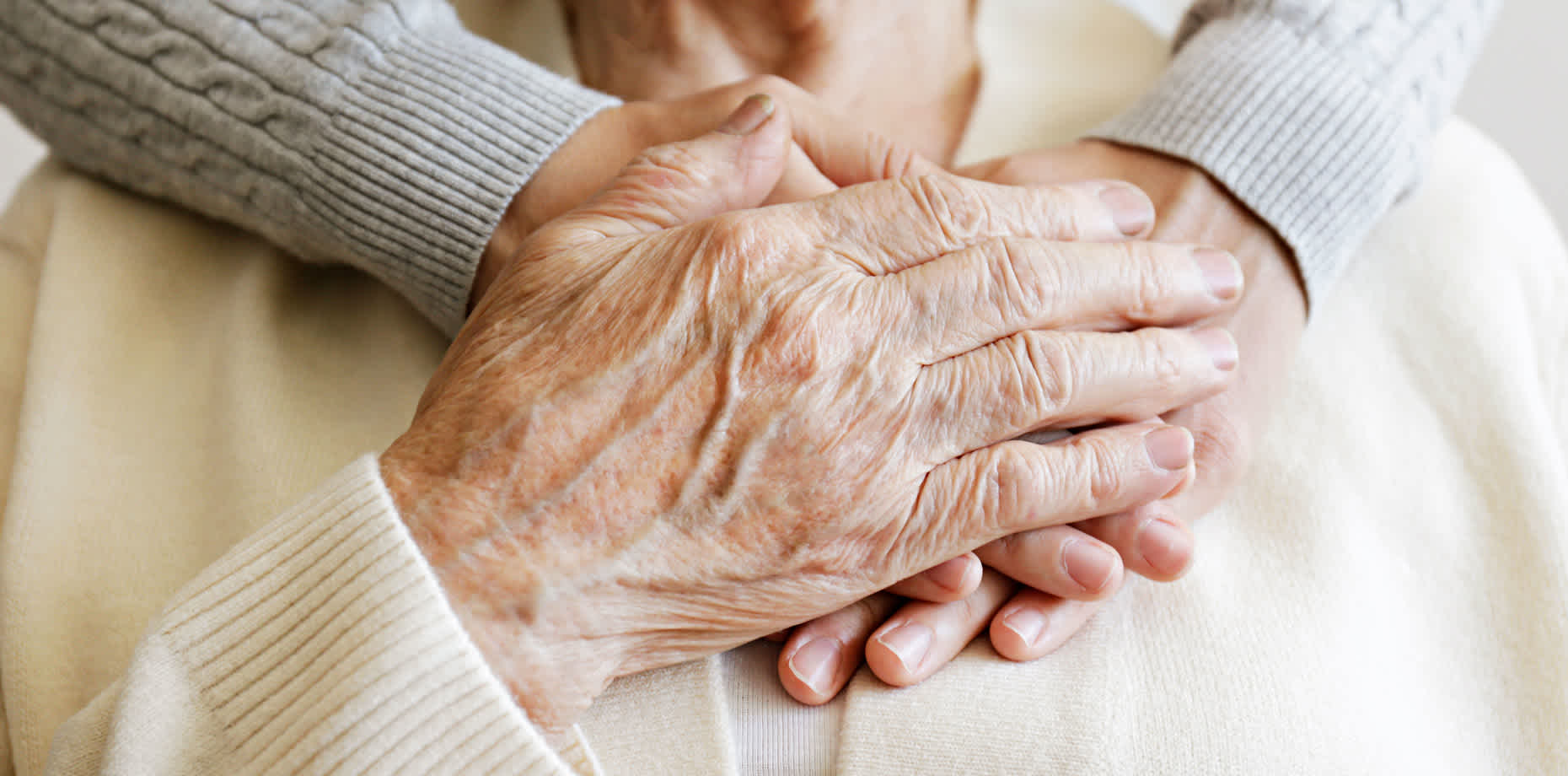 Close-up of older couple’s hands held together