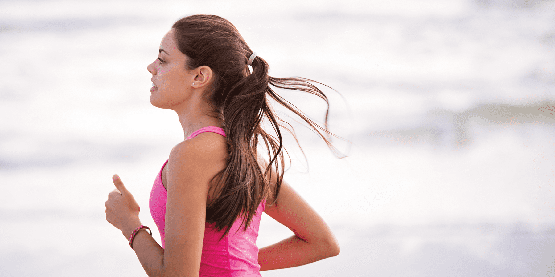 Woman jogging outside while wondering why metabolism is important for understanding health