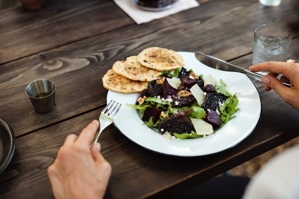 Person about to eat dinner while wondering about the reasons for high cholesterol other than diet
