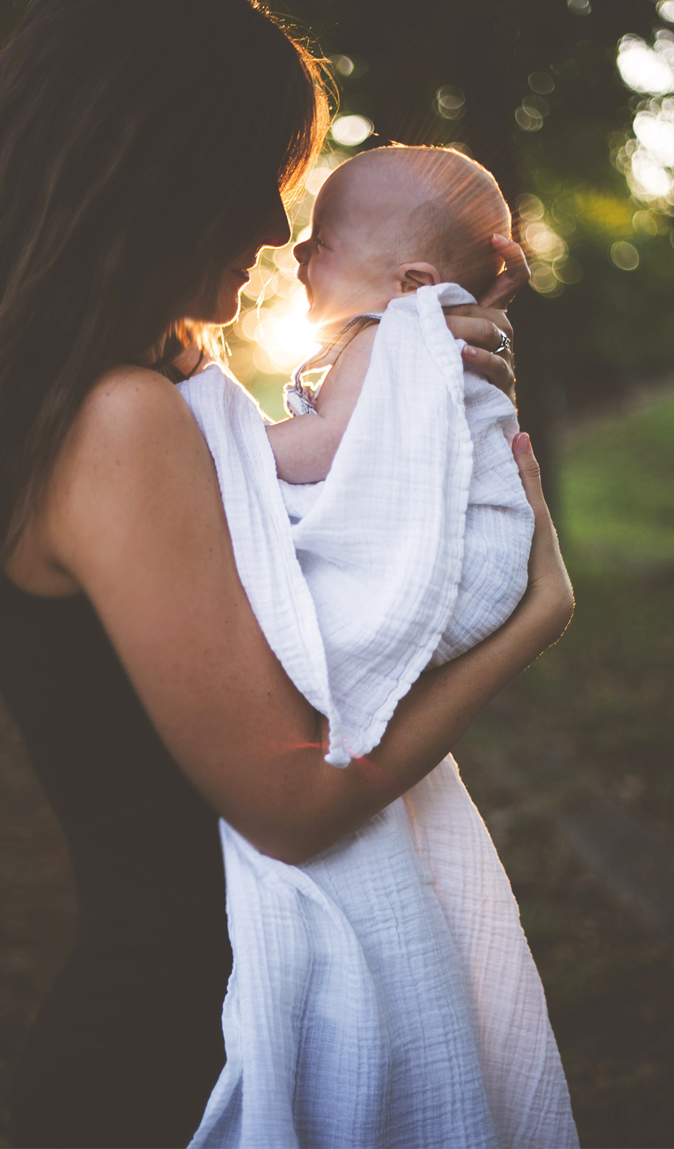 Woman holding baby and thinking about her fertility 