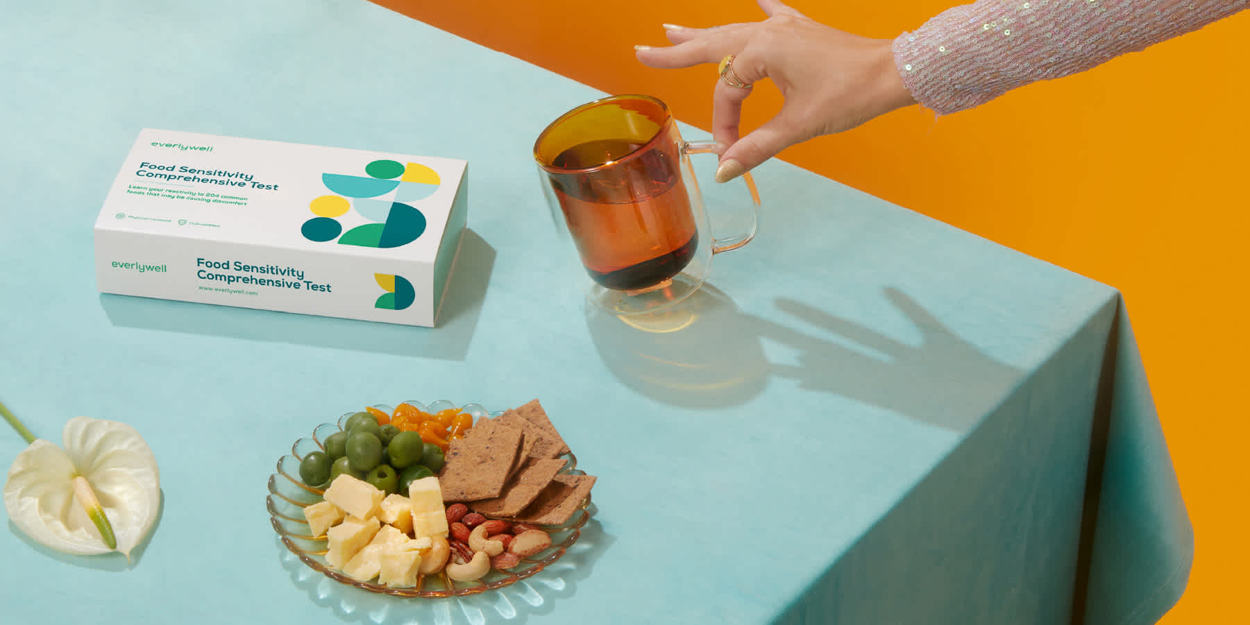 Photo of an Everlywell Food Sensitivity Comprehensive Test and a plate of food.