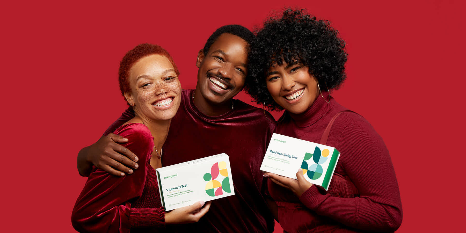 Three people holding Vitamin D Test and Food Sensitivity Test