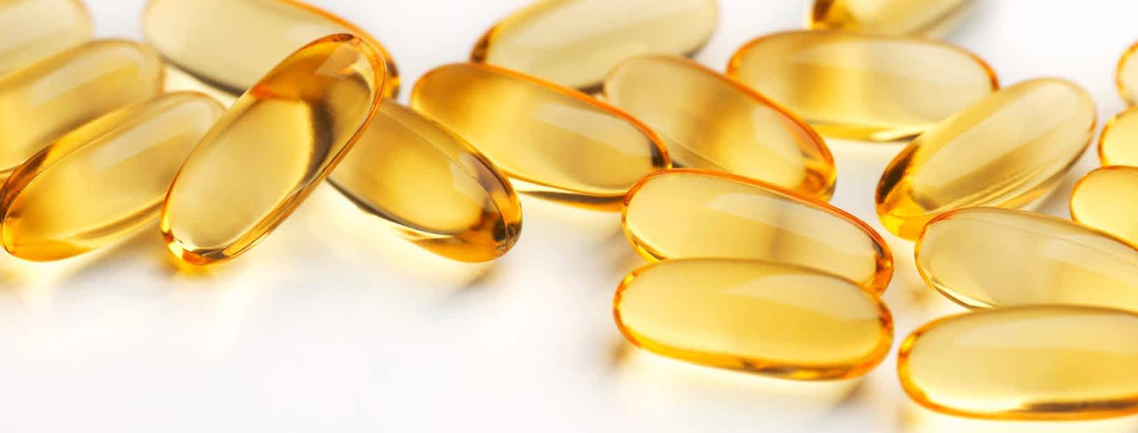 Fish oil supplements on white background