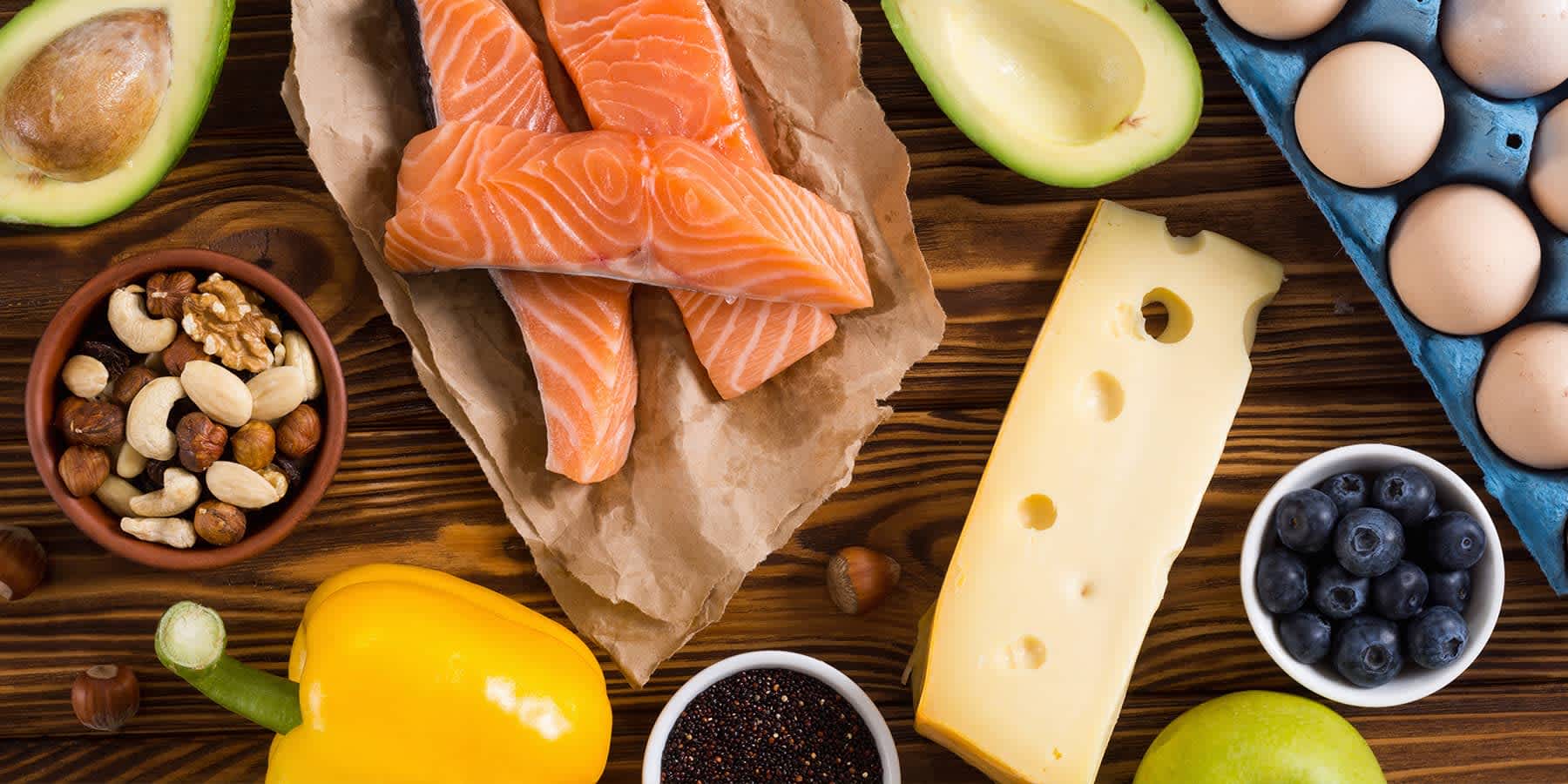 Various nutrient dense foods such as salmon and avocados on a table