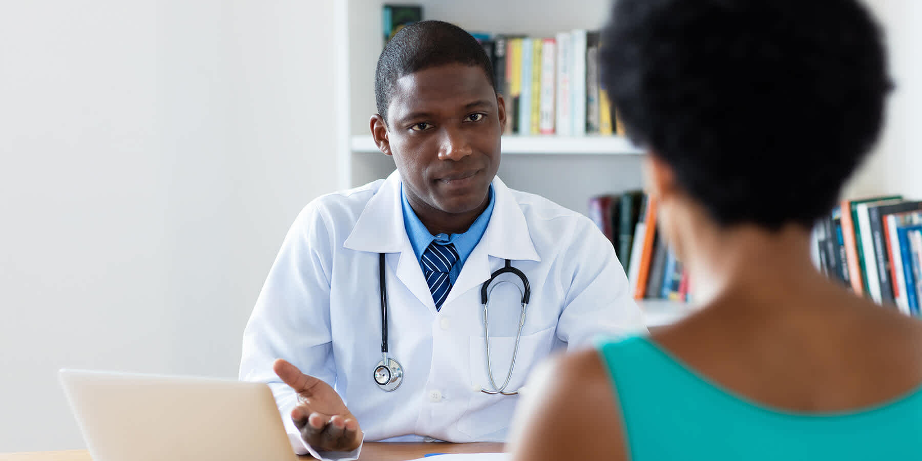 Healthcare provider speaking to a patient about hep b treatment
