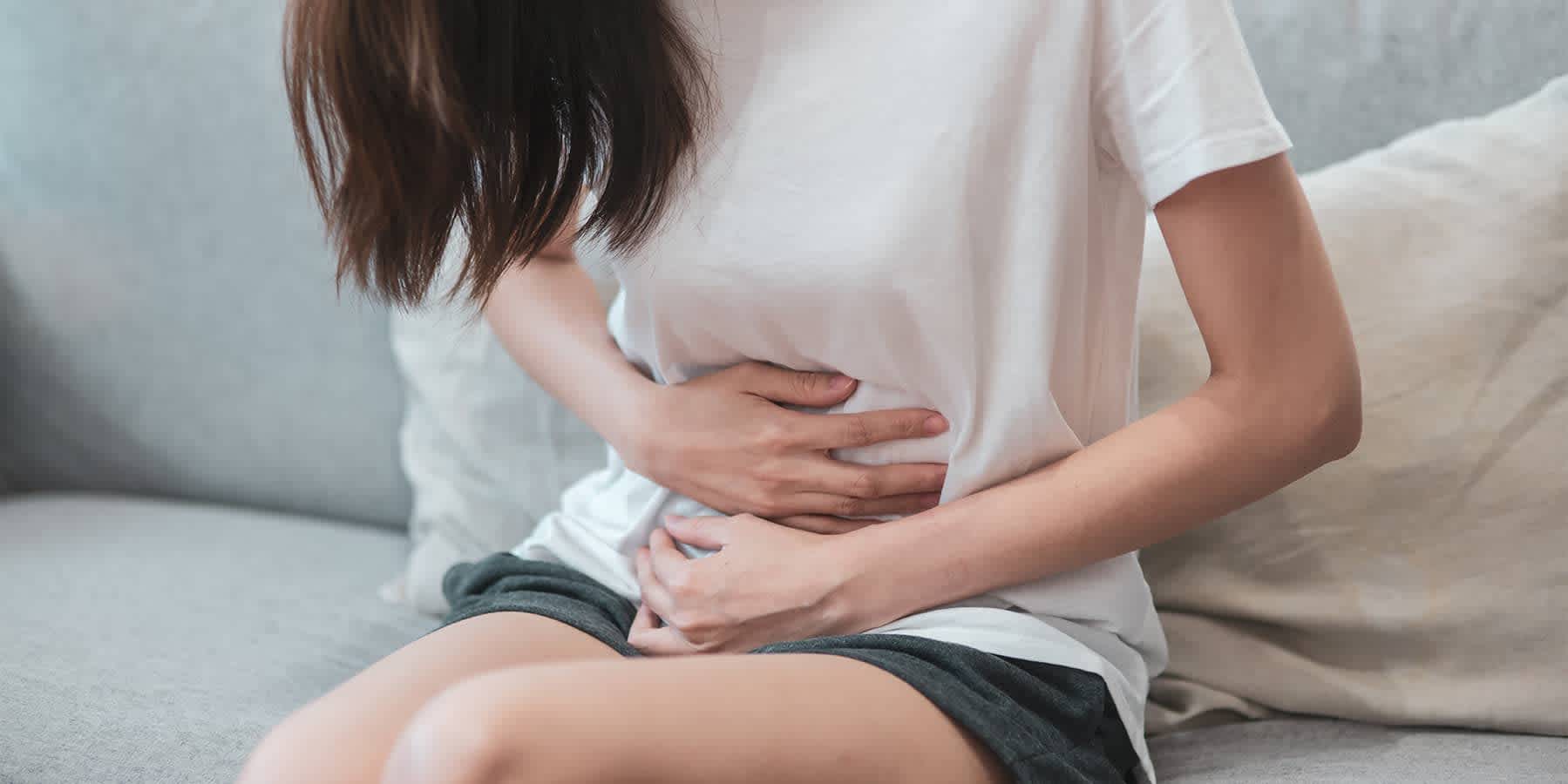 Woman experiencing uncomfortable symptoms from having chlamydia and gonorrhea at the same time