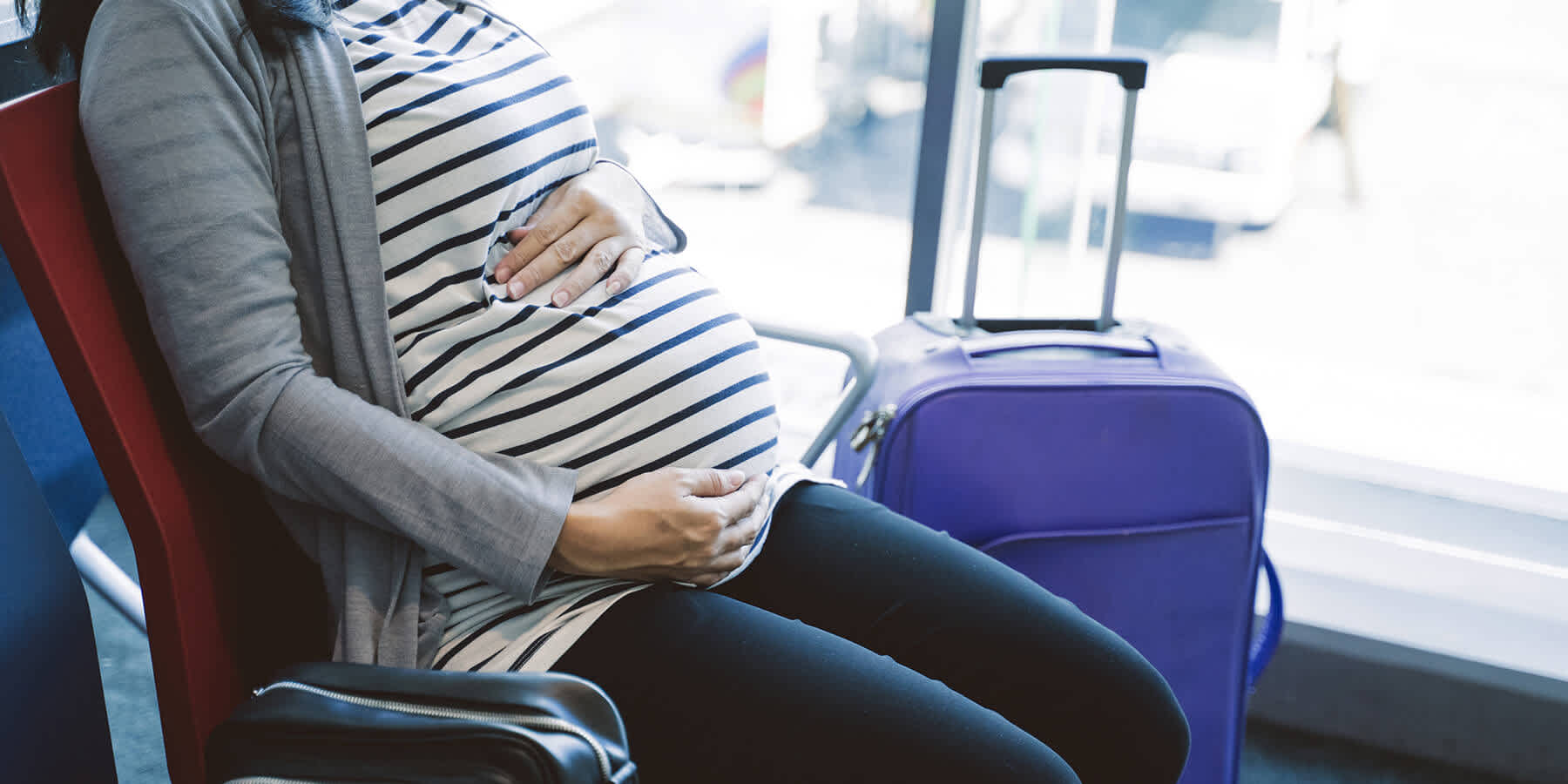 Pregnant woman sitting down and experiencing a change in bowel habits