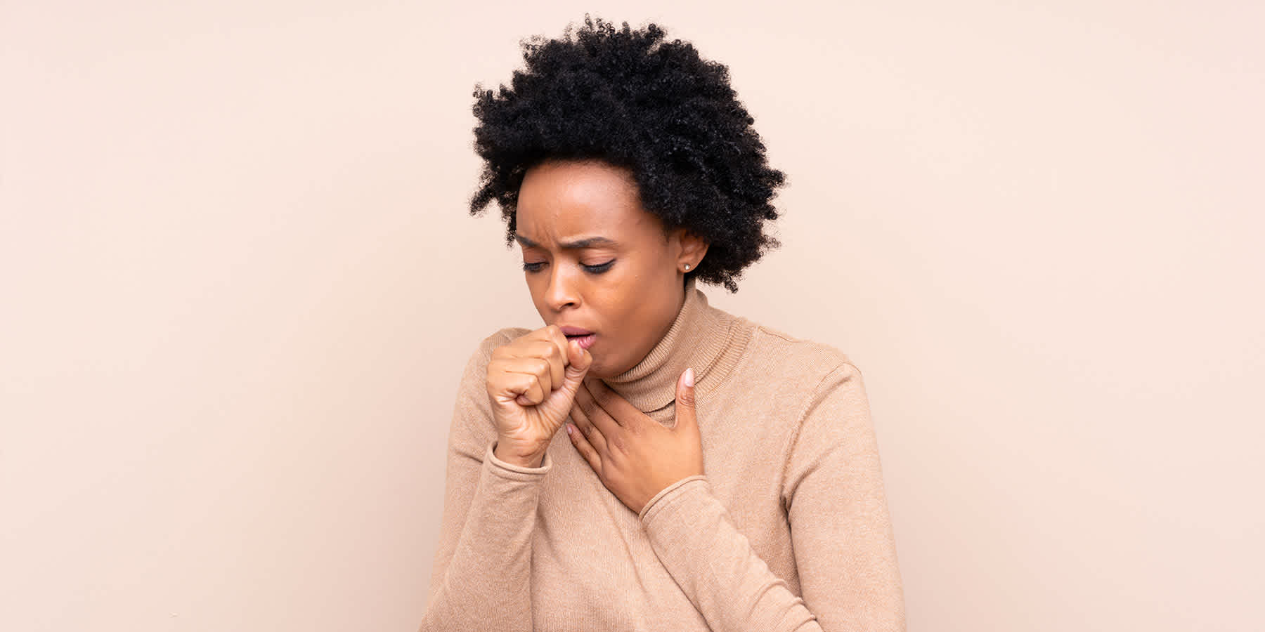 Woman coughing as symptom of low white blood cell count
