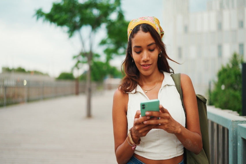 woman walking and holding phone