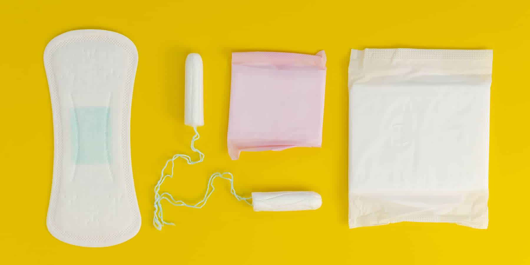 Pads and other period care items against a yellow background