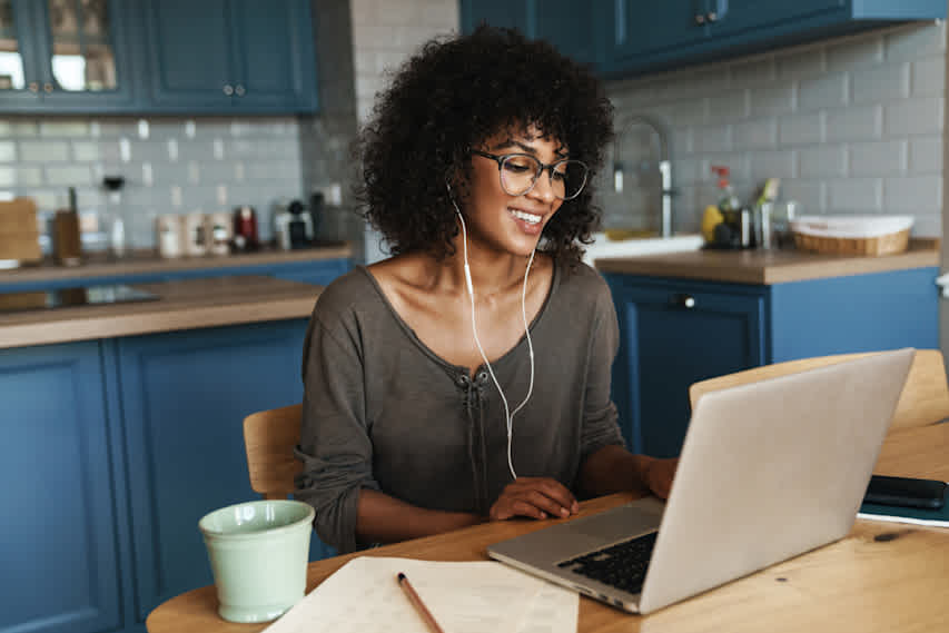 woman at computer with paper and pencil