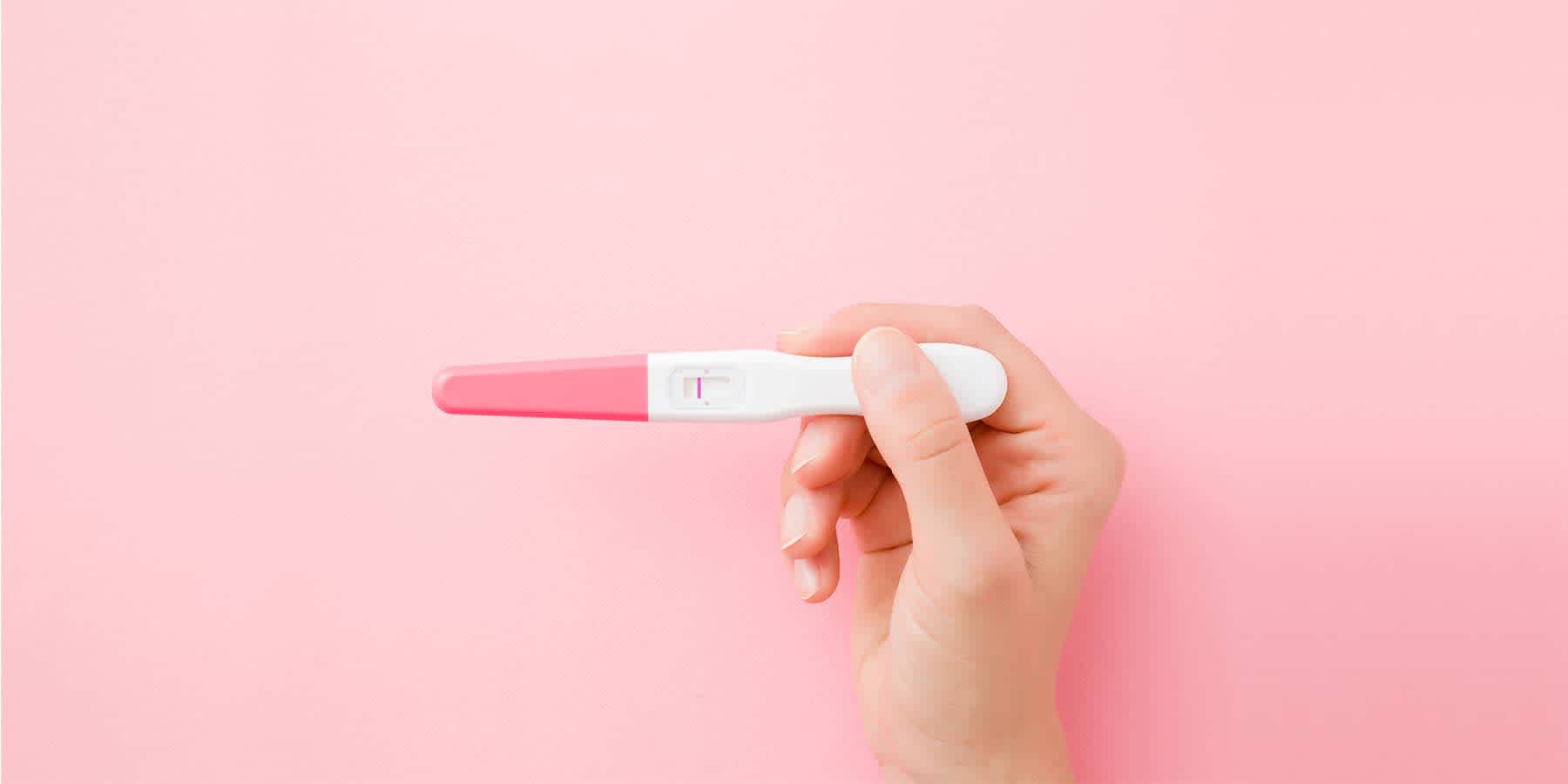 Person holding pregnancy test results after finding out what ovarian reserve means