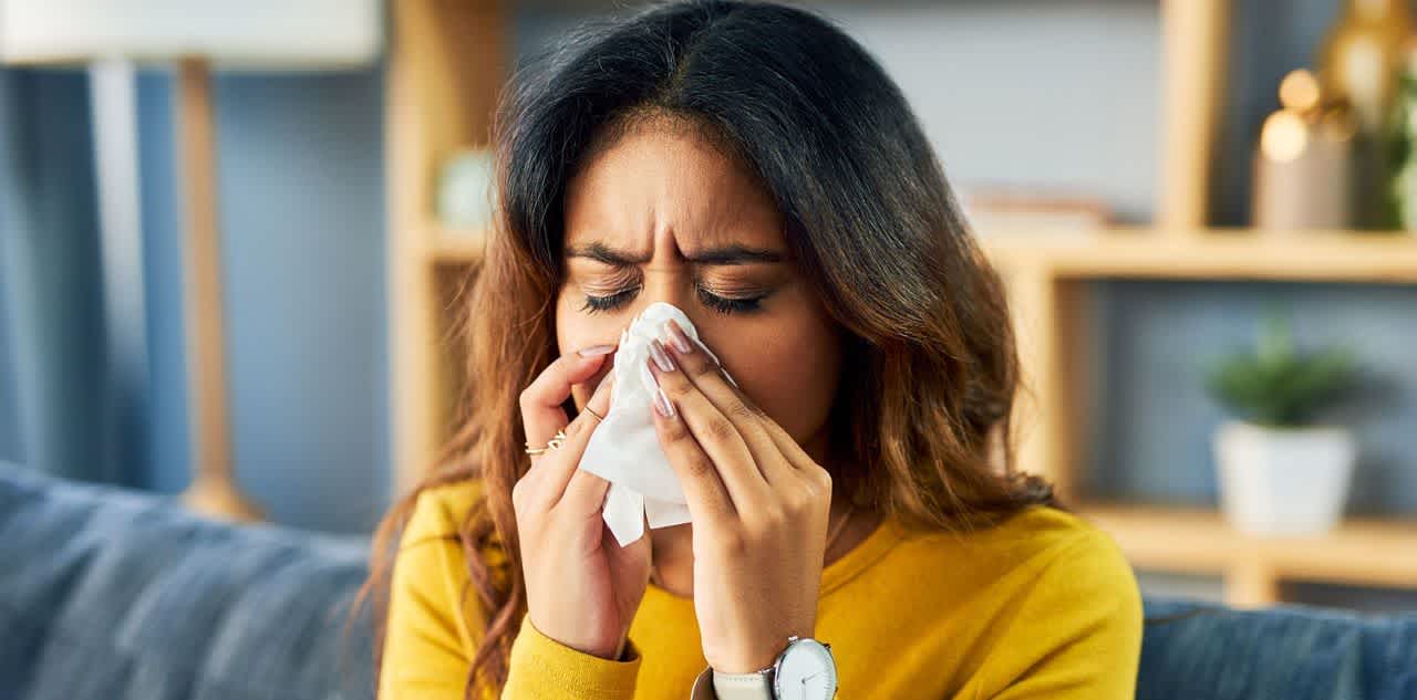 Woman with allergies sneezing and wondering how to test for allergies