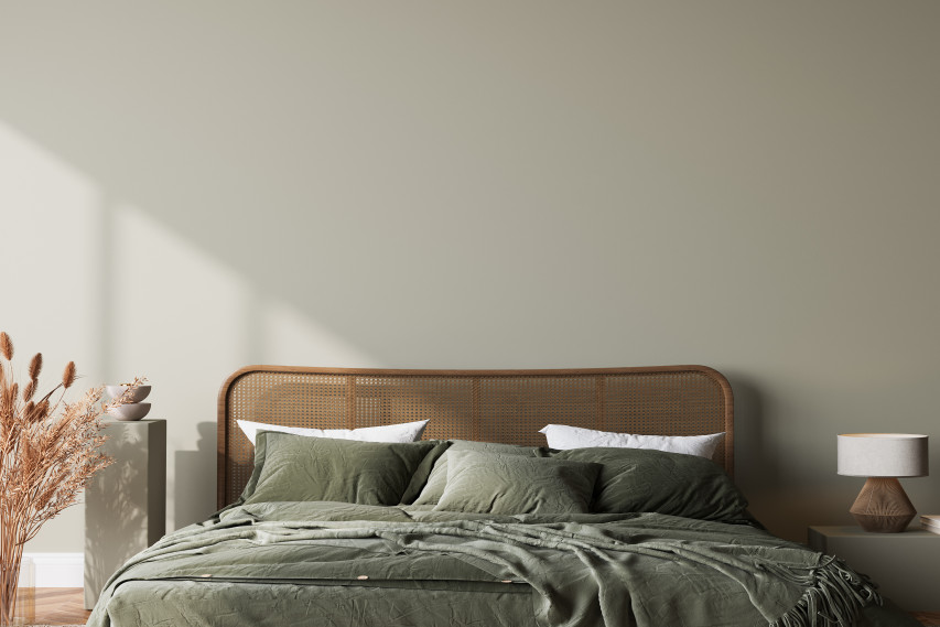 green bed with cane headboard