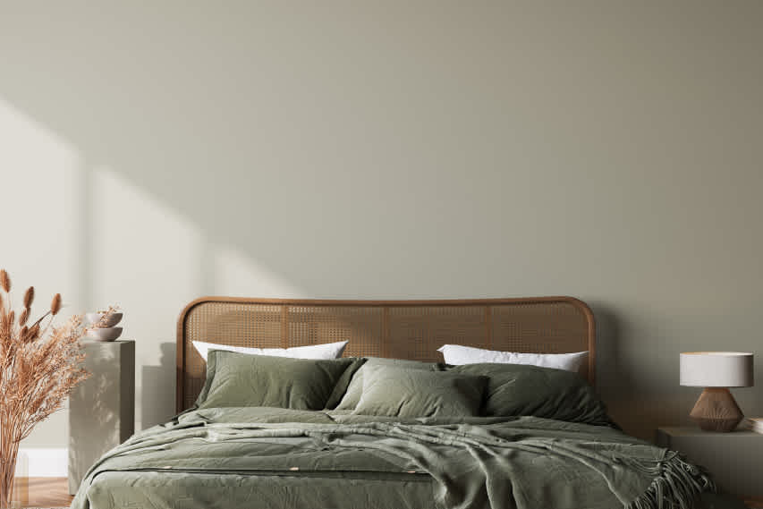 green bed with cane headboard