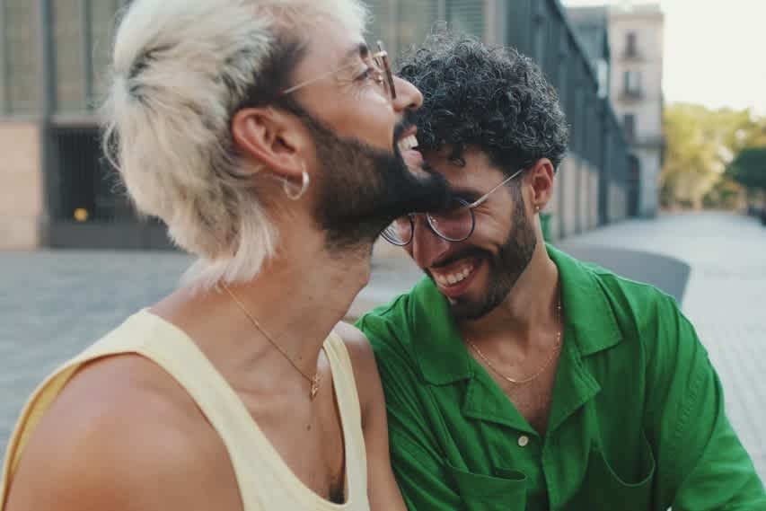 two men sitting and laughing