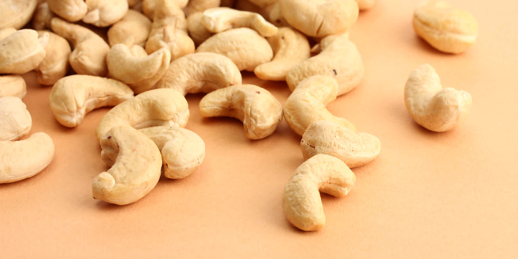 Cashews piled on table to represent protein that may be good for weight loss