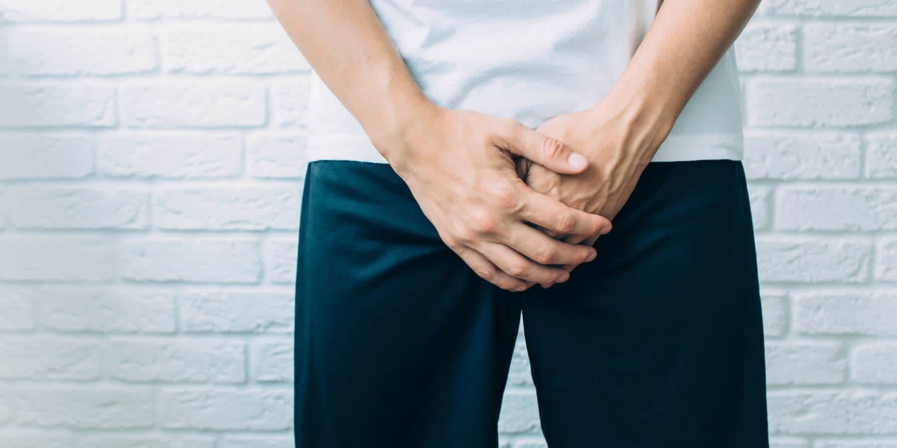 Man with hands over his groin wondering about bumps on penis