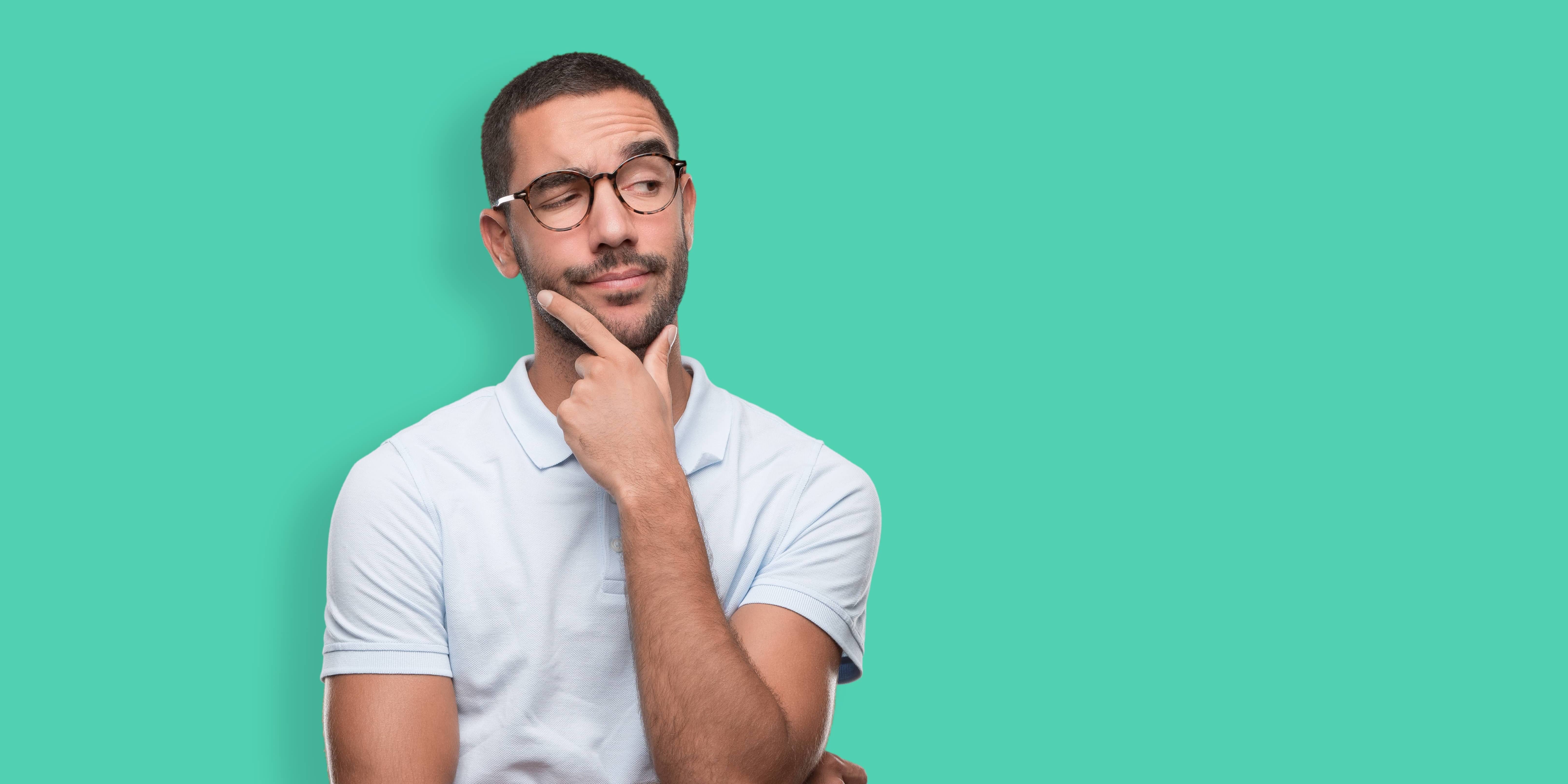 Young man stroking chin while wondering about the worst foods for erectile dysfunction