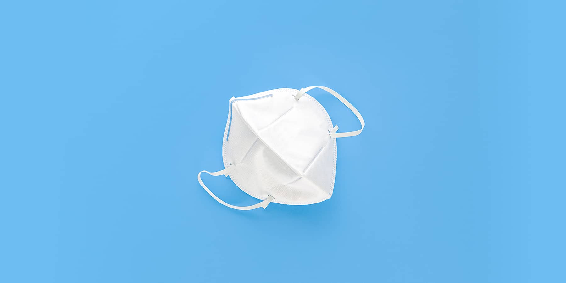 Image of mask for COVID-19 against a blue background
