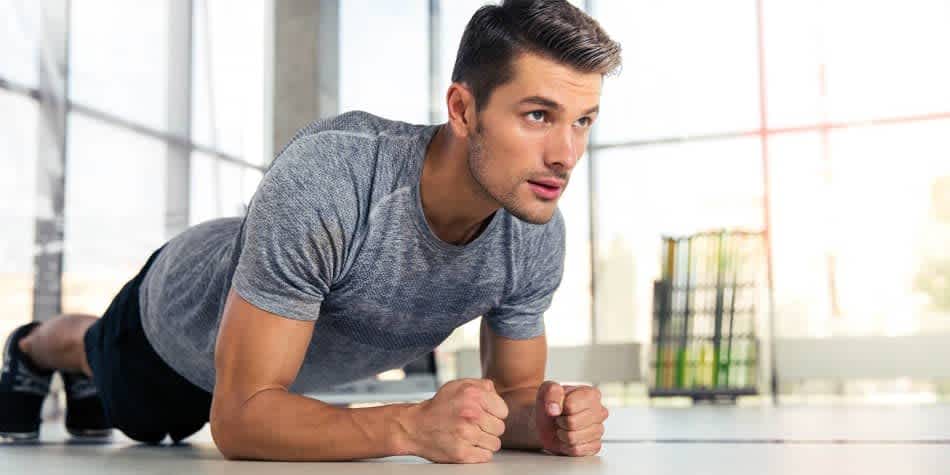 Young man doing push-ups while thinking about the connection between testosterone and weight loss