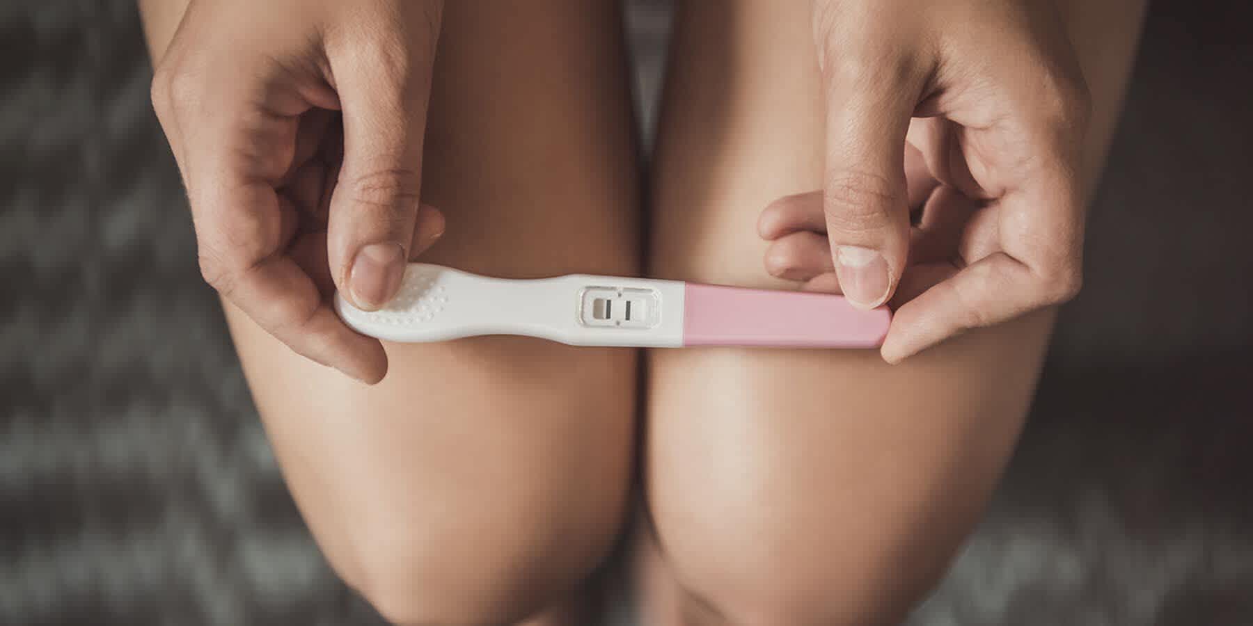 Woman with high fertility looking at pregnancy test result