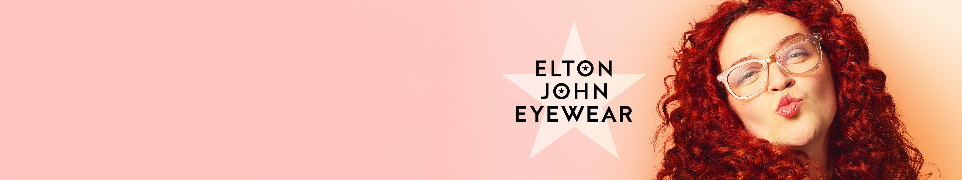 Person with long curly red hair and Elton John Glasses puckers lips in front of a peach background; "Elton John Eyewear" text appears on the left.