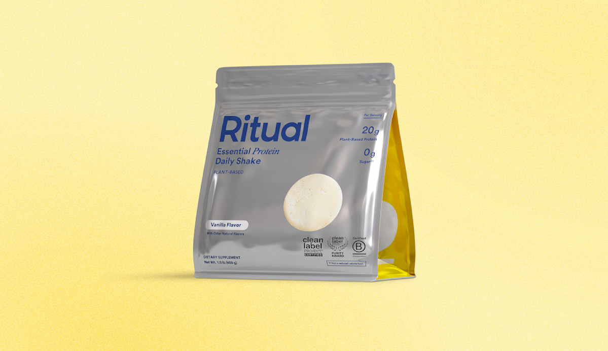 Package of Essential Protein Daily Shake on a yellow gradient background.
