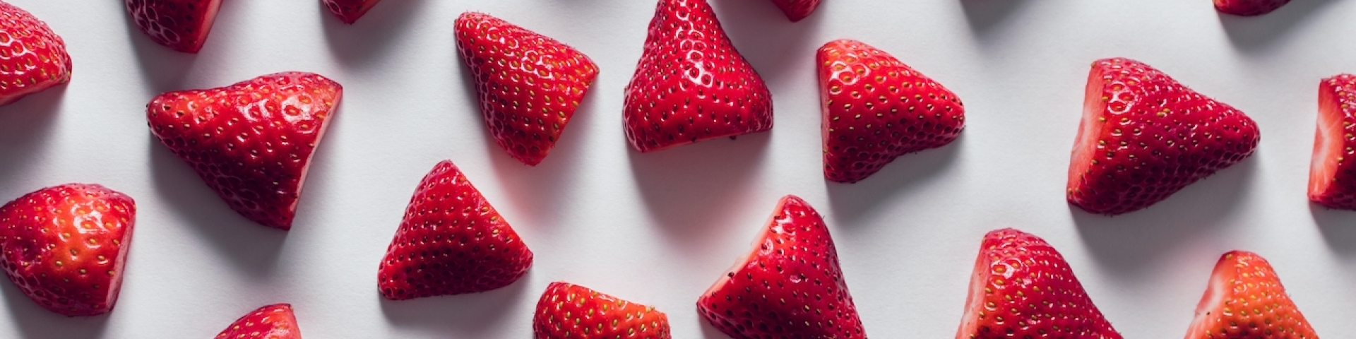 Several strawberries sliced in half to be used in a gut health smoothie.