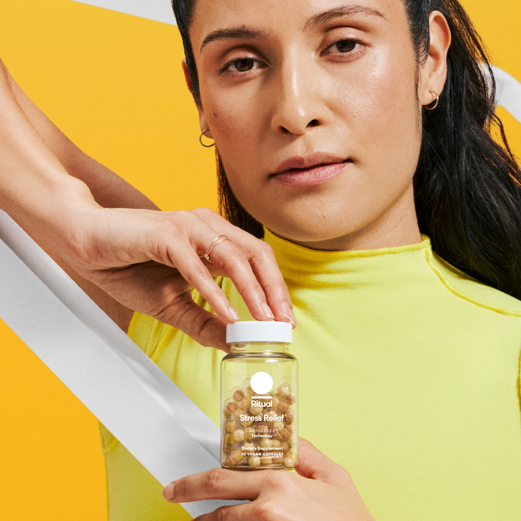 Model holding a bottle of Stress Relief in front of them