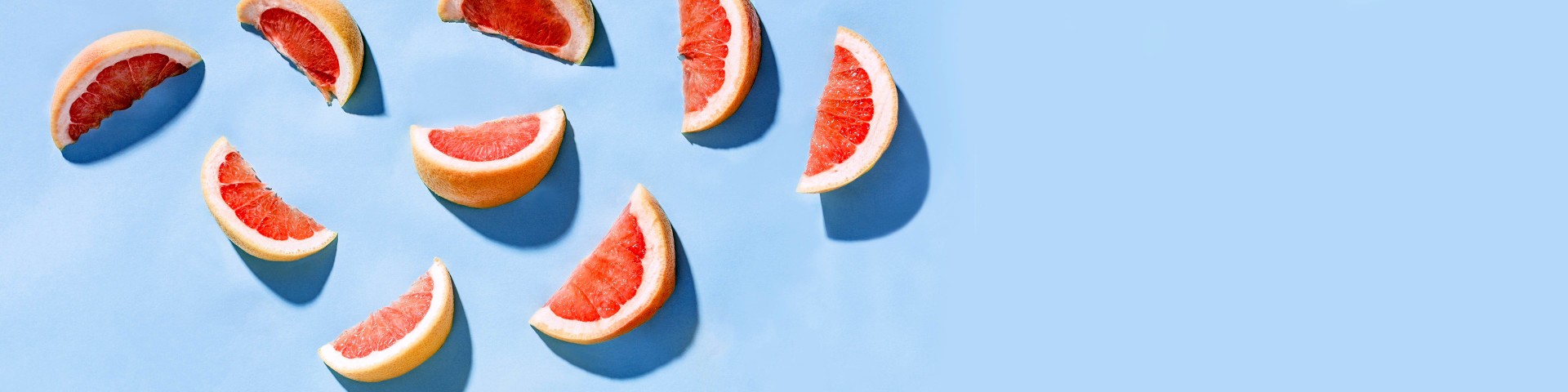 Grapefruit slices on a blue background.