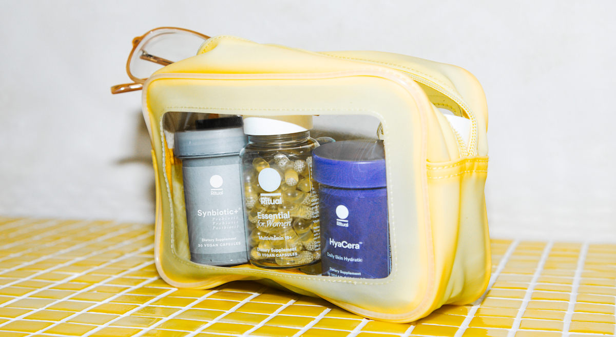 Three Ritual products located inside of a yellow travel cosmetics bag.