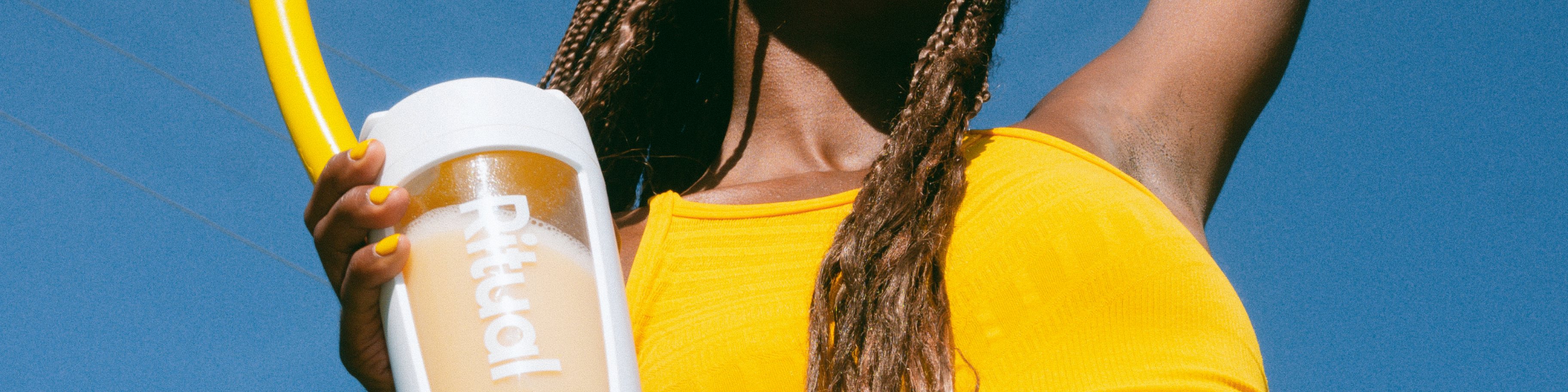 Ritual protein being held by a woman exercising in yellow.